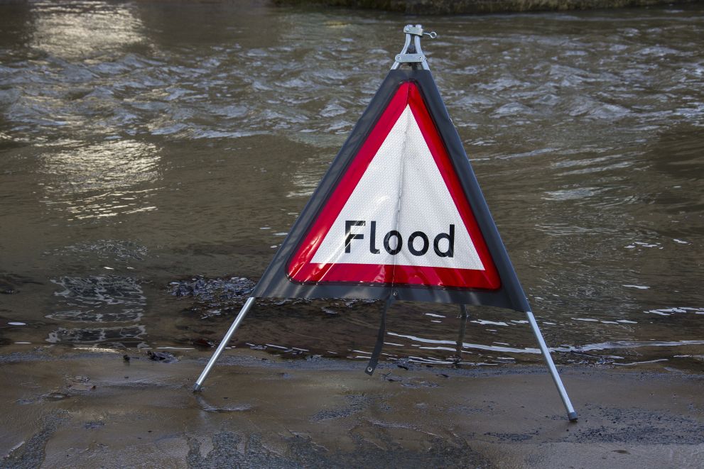A photo of a flood with a sign that says flood.