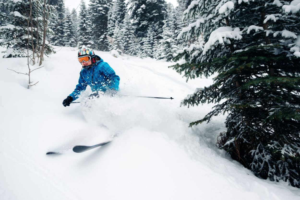 A person skiing through soft, fluffy snow.