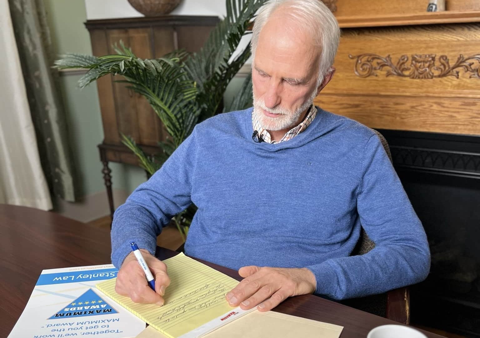 Joe Stanley taking notes in his office. Working very hard for a client