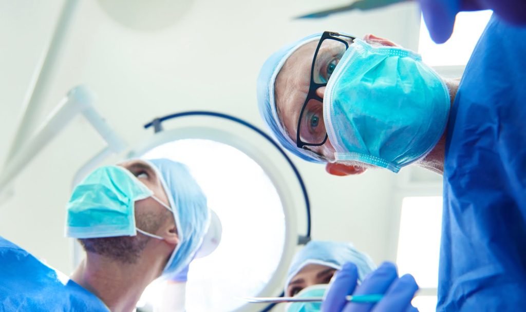 The view of a patient during operation, the doctor. is looking down with scalpel in hand.